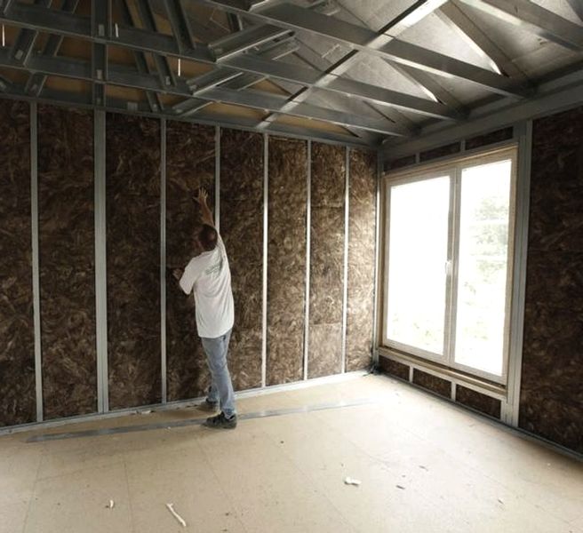 Persona poniendo tiras de aluminio para paredes